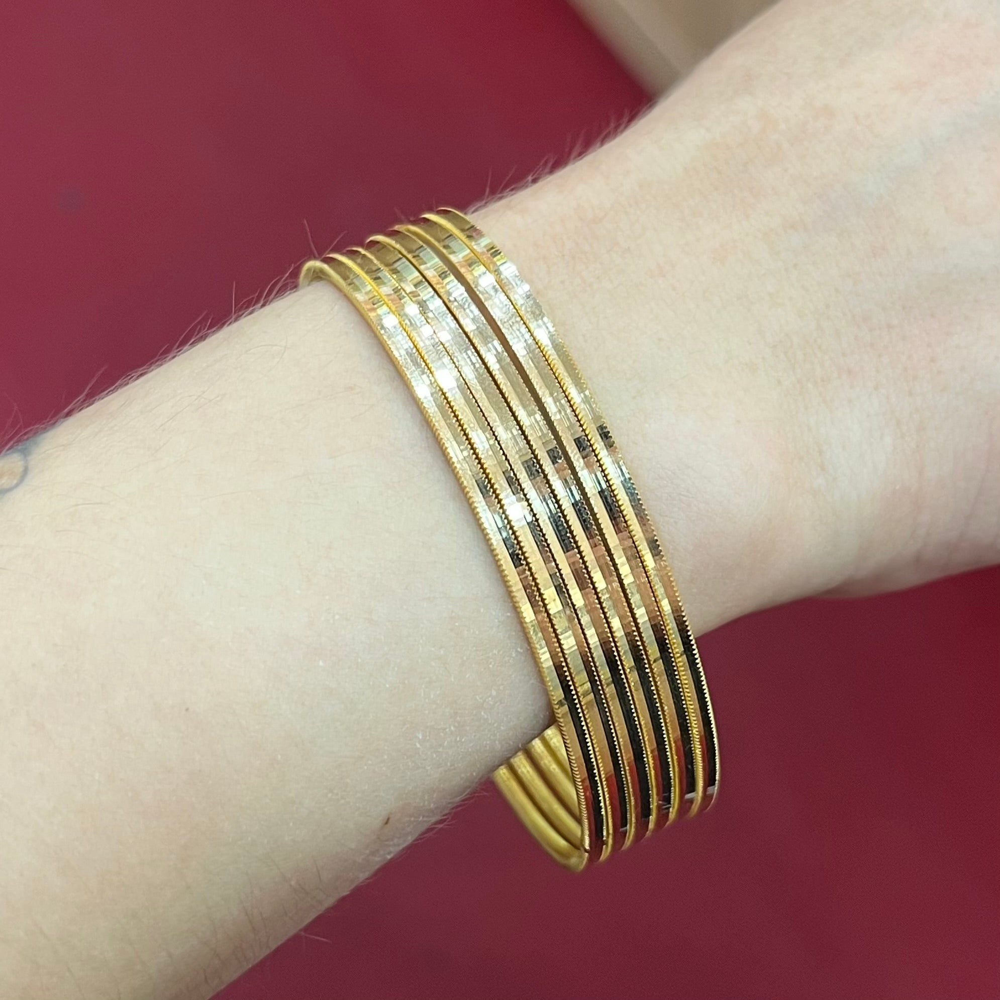 Mehrere 916 Ajda Armreifen aus 22 Karat Gelbgold elegant kombiniert am Handgelenk getragen